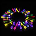 6.5 metre long solar-powered LED garden string lights with white bubble drop shaped lamps on a green lawn