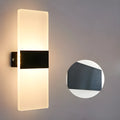 Modern LED bedside wall lamp with acrylic shade, 27x10cm, in black finish, mounted on a wall