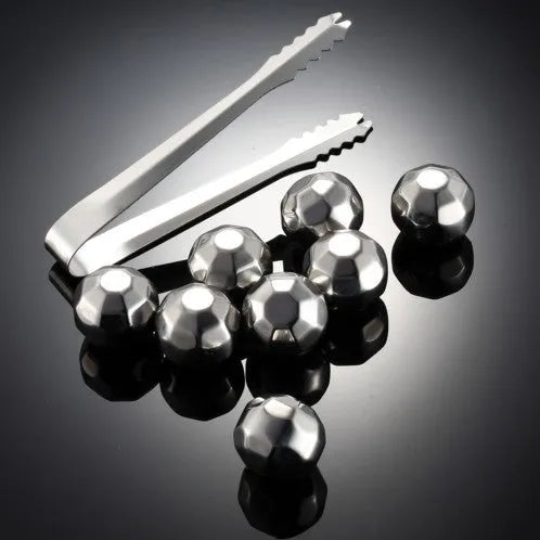 Set of 8 stainless steel ice cubes in square and ball shapes with plastic storage box and tong on a wooden surface