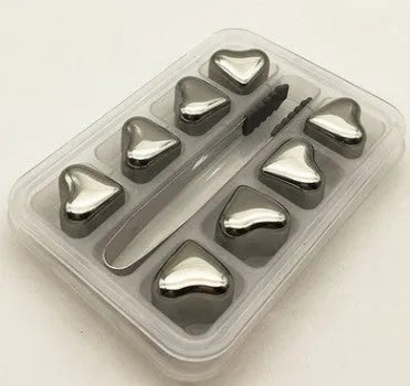 Set of 8 stainless steel ice cubes in square and ball shapes with plastic storage box and tong on a wooden surface