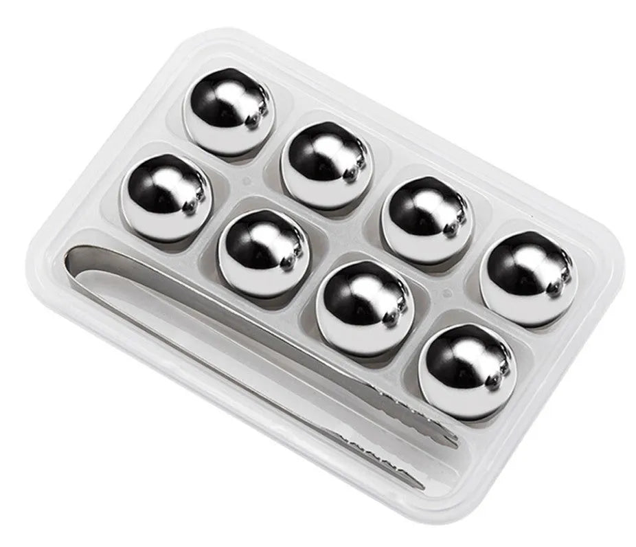 Set of 8 stainless steel ice cubes in square and ball shapes with plastic storage box and tong on a wooden surface