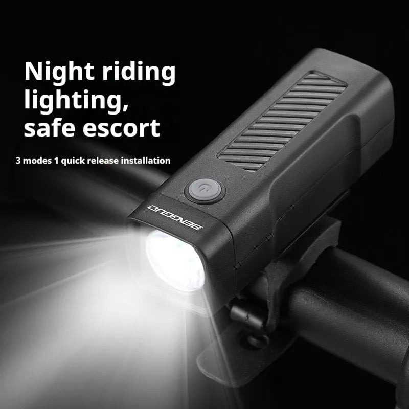 Black bicycle headlight with LED lens mounted on handlebars via a quick-release strap bracket.