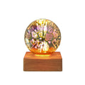 USB 3D firework crystal ball night light with warm LED, touch control, and starry sky effect on a wooden desk