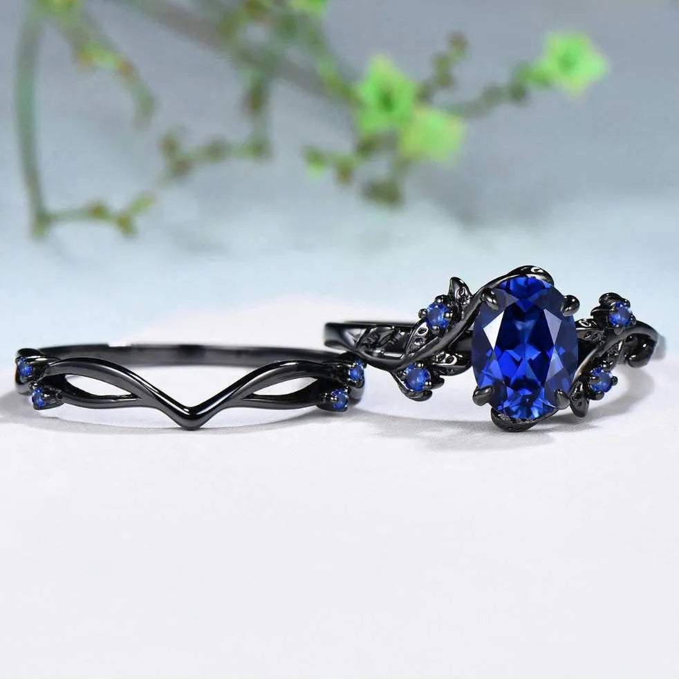 Black gun finish women's ring with navy blue rhinestone inlay on copper geometric band