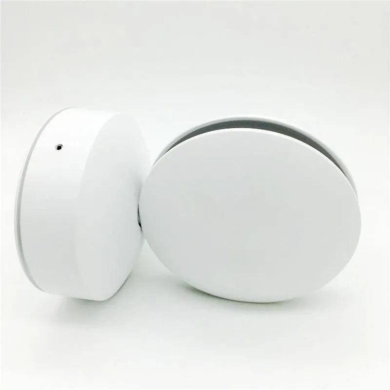 Modern aluminium LED spotlight bar wall lamp emitting coloured light, mounted on a wall.