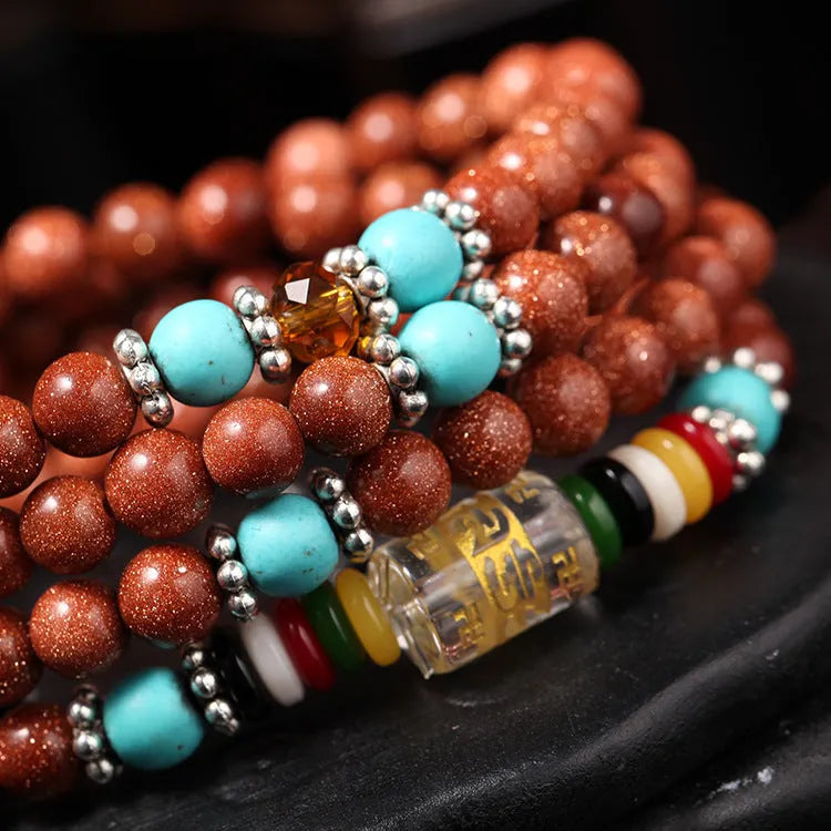 Golden star stone and nugget sand multi-circle bracelet with fu character on a retro-style chain.