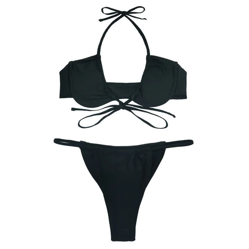Women's black and mint green two-piece nylon bikini swimsuit on a white background.
