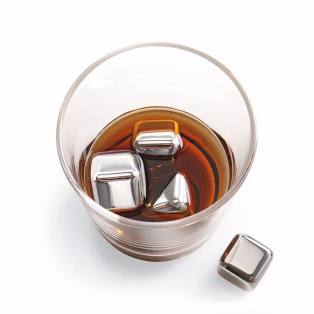 Set of 8 stainless steel ice cubes in square and ball shapes with plastic storage box and tong on a wooden surface