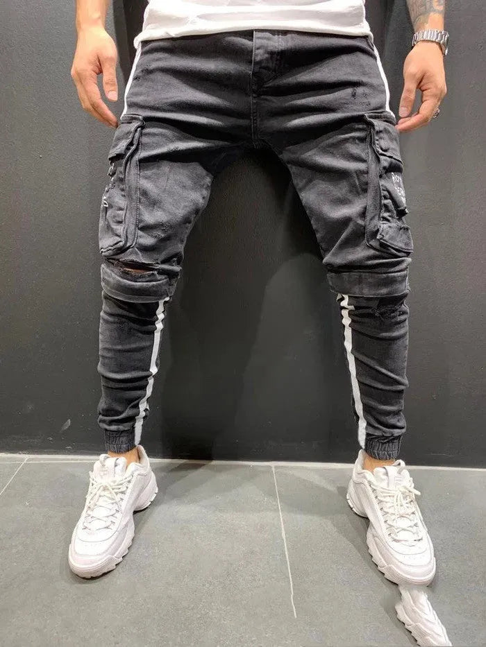 Men's denim knee-cut zipper trousers in black, 80% cotton, side view showing zipper placket and knee cut detail