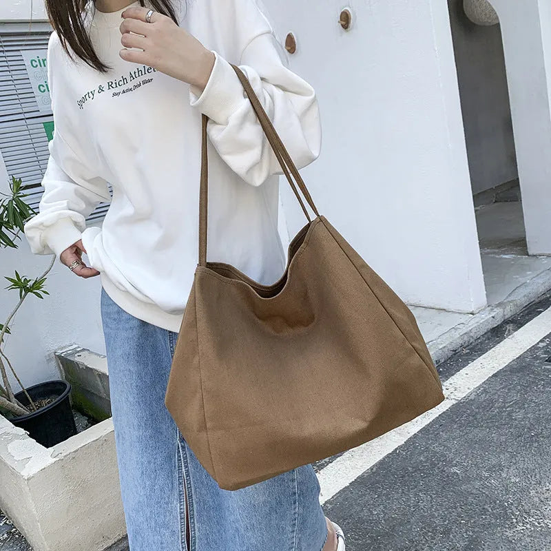 Solid colour women's canvas handbag in black with double shoulder straps and external sandwich pocket
