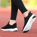Women's running shoes in black, pink, or white with a fly weave upper and durable sole.