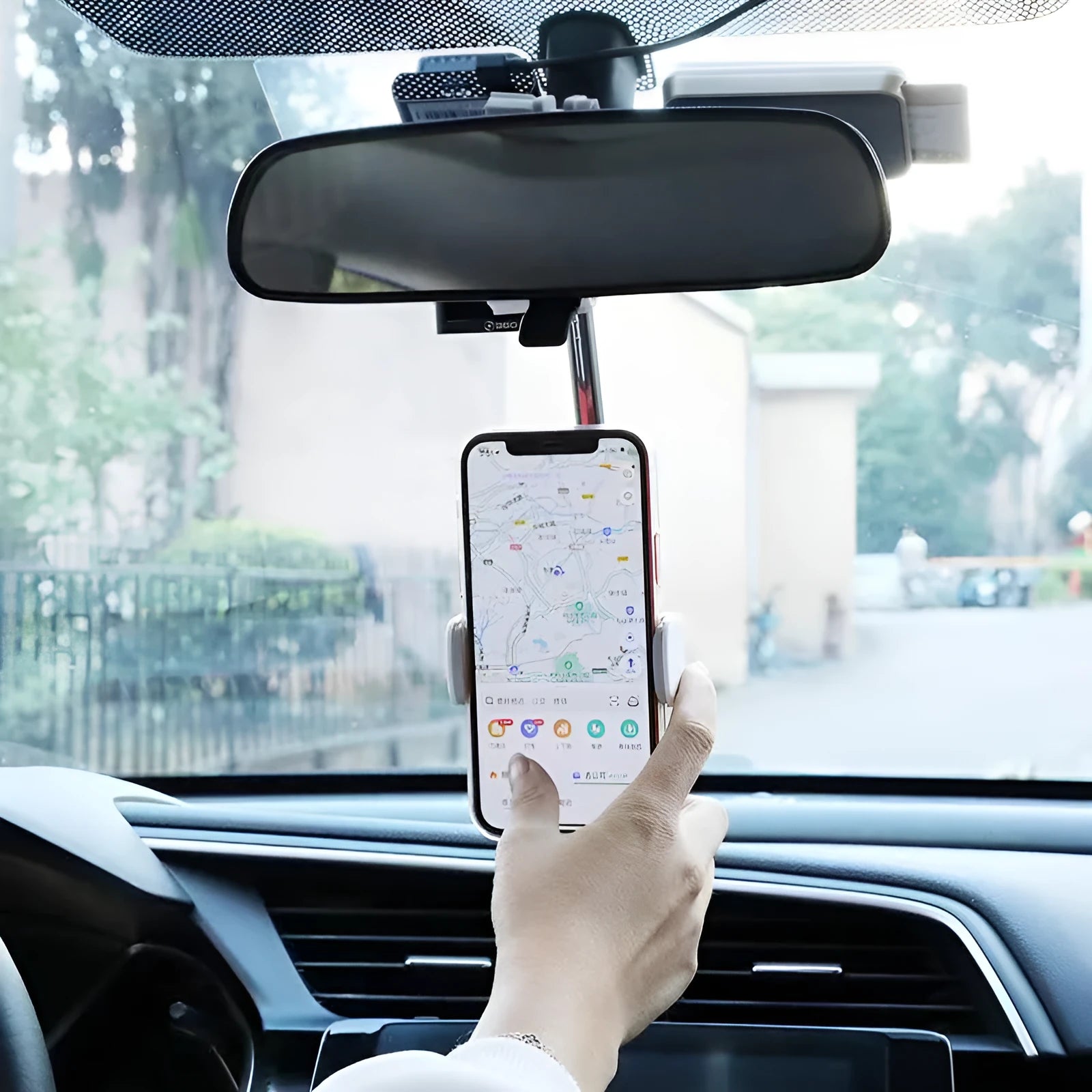Black ABS plastic mobile phone bracket mounted on car rearview mirror showing smartphone in holder