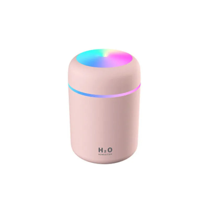 Car air purifying humidifier in pink with USB cable, cool mist from nozzle, compact design for dashboard or desk