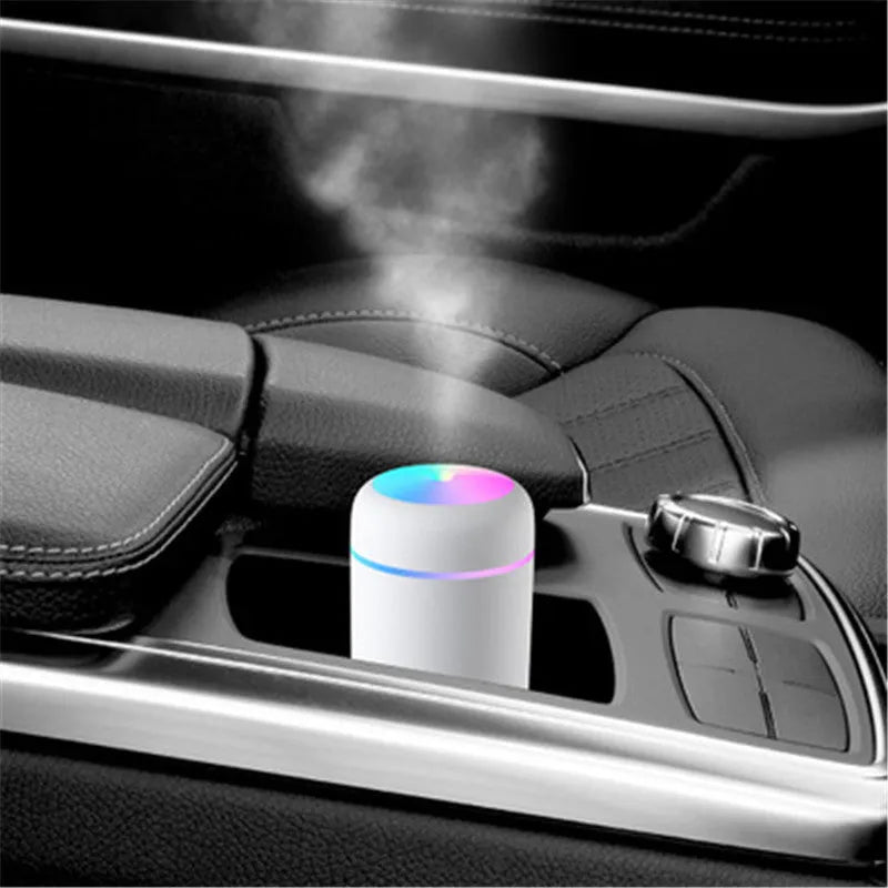 Car air purifying humidifier in pink with USB cable, cool mist from nozzle, compact design for dashboard or desk