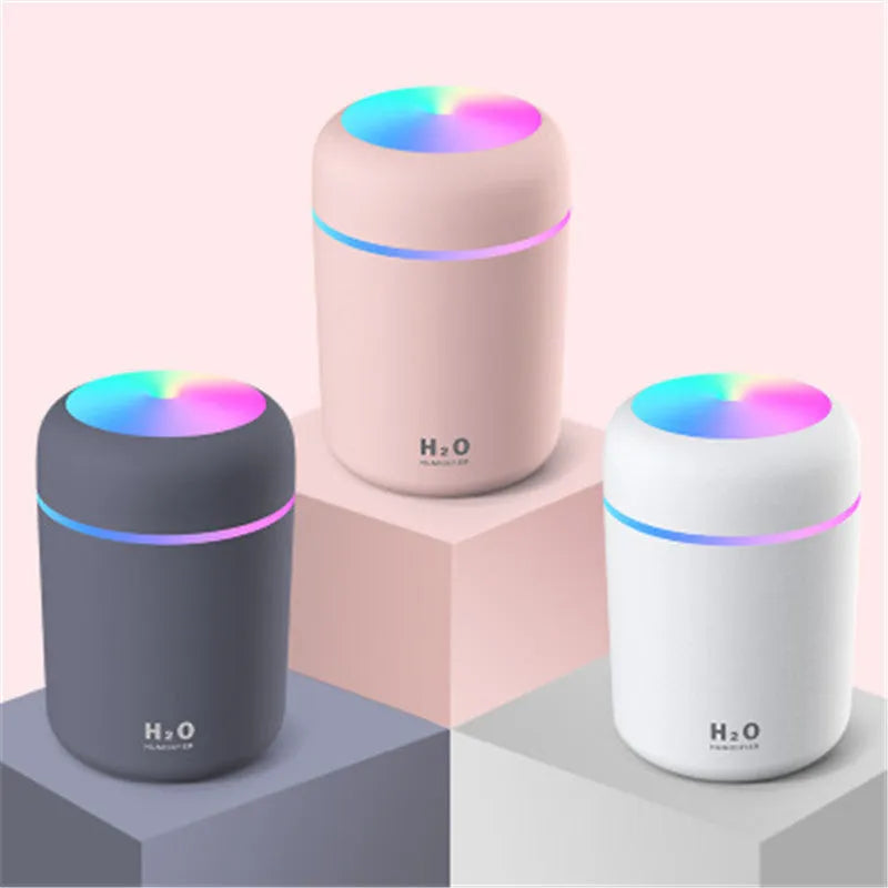 Car air purifying humidifier in pink with USB cable, cool mist from nozzle, compact design for dashboard or desk