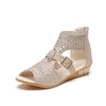 Women's beige flat sandals with a fish mouth toe, low wedge heel, and a back zipper fastener.