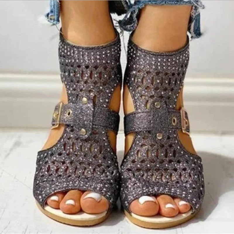 Women's beige flat sandals with a fish mouth toe, low wedge heel, and a back zipper fastener.