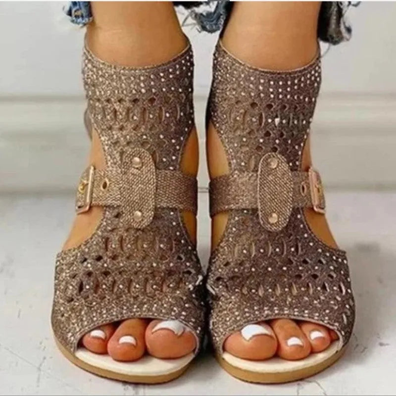 Women's beige flat sandals with a fish mouth toe, low wedge heel, and a back zipper fastener.