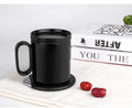 Wireless charging warm coaster in black porcelain with a cup placed on top, showing USB cable