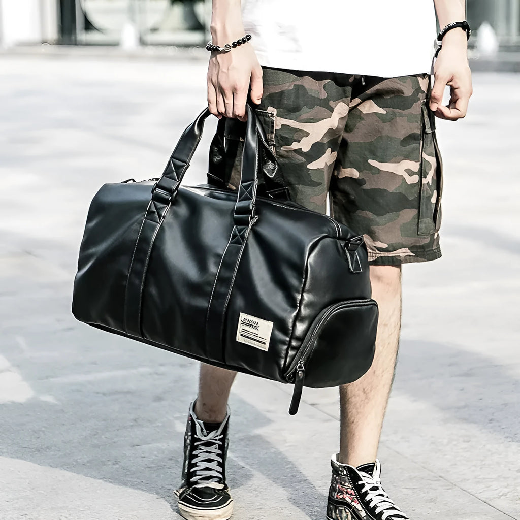 Large black PU leather sports training bag with a single shoulder strap and multiple internal compartments.