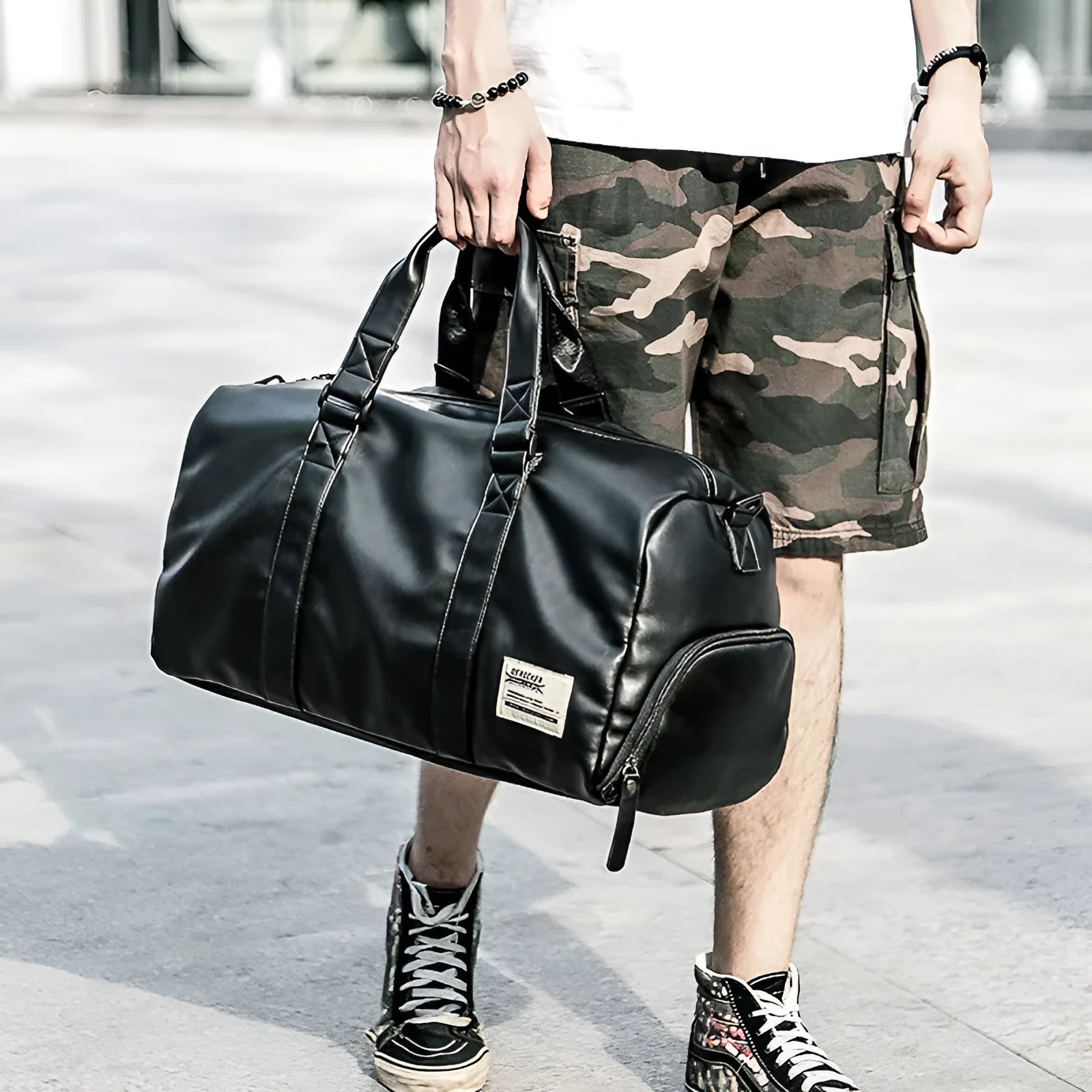 Large black PU leather sports training bag with a single shoulder strap and multiple internal compartments.