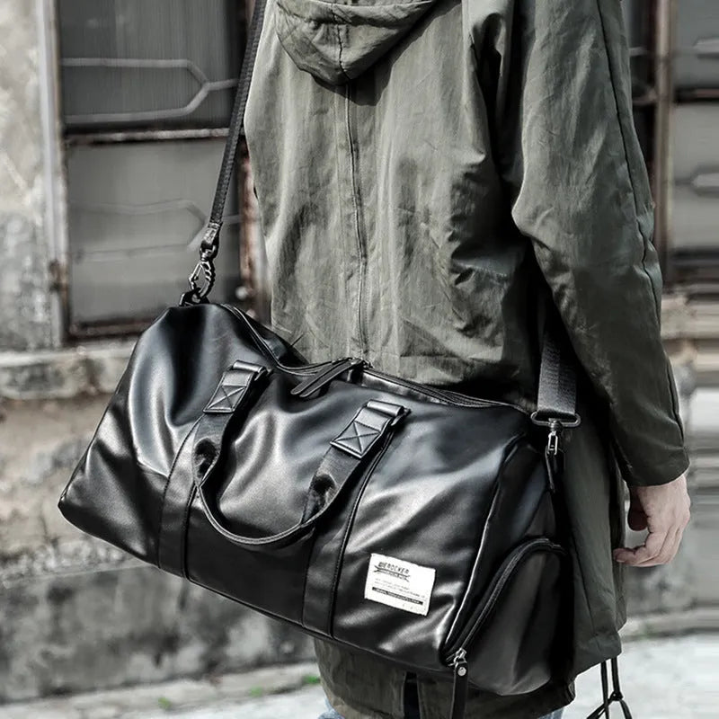 Large black PU leather sports training bag with a single shoulder strap and multiple internal compartments.