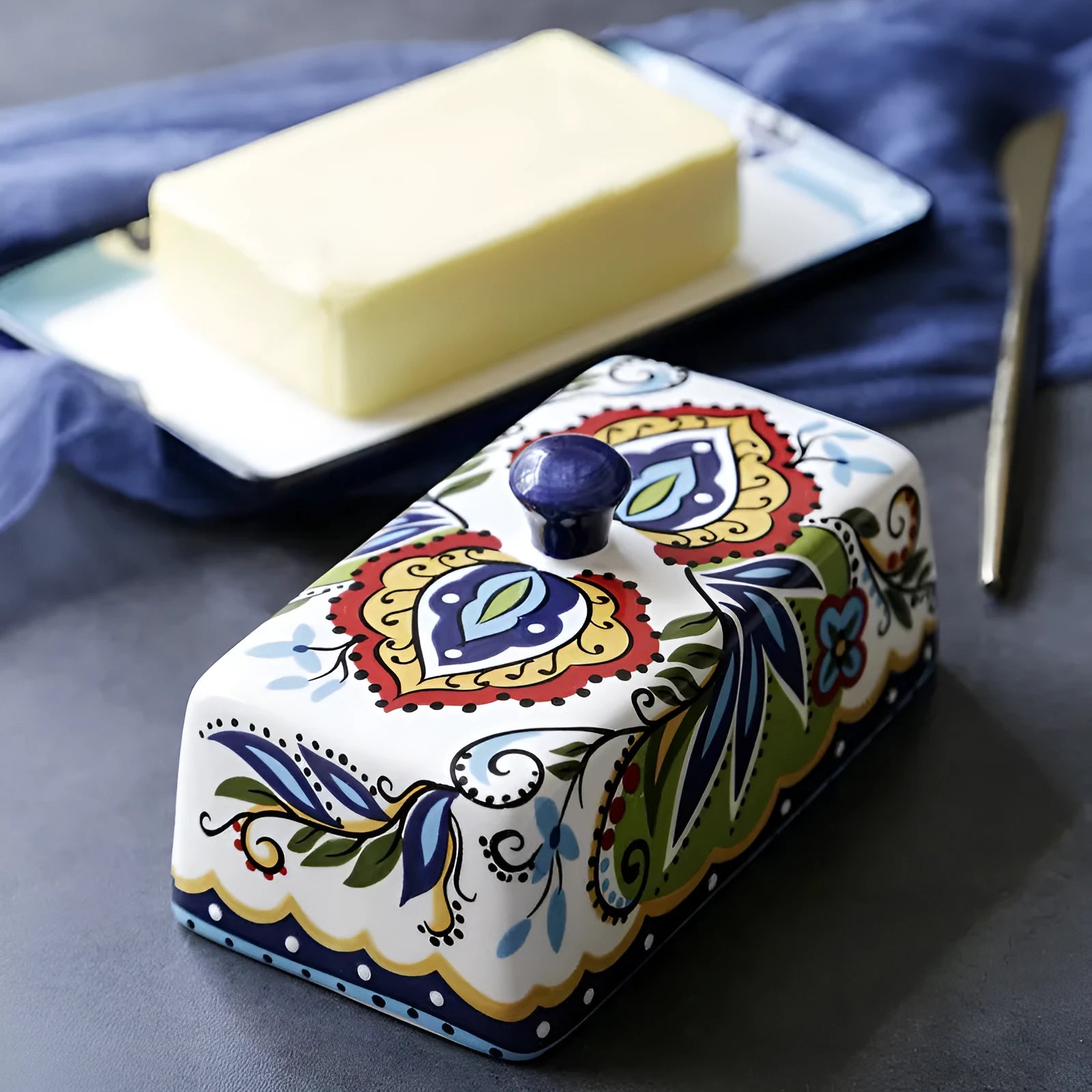 Square ceramic butter box with lid in white, underglaze flower pattern, on kitchen counter
