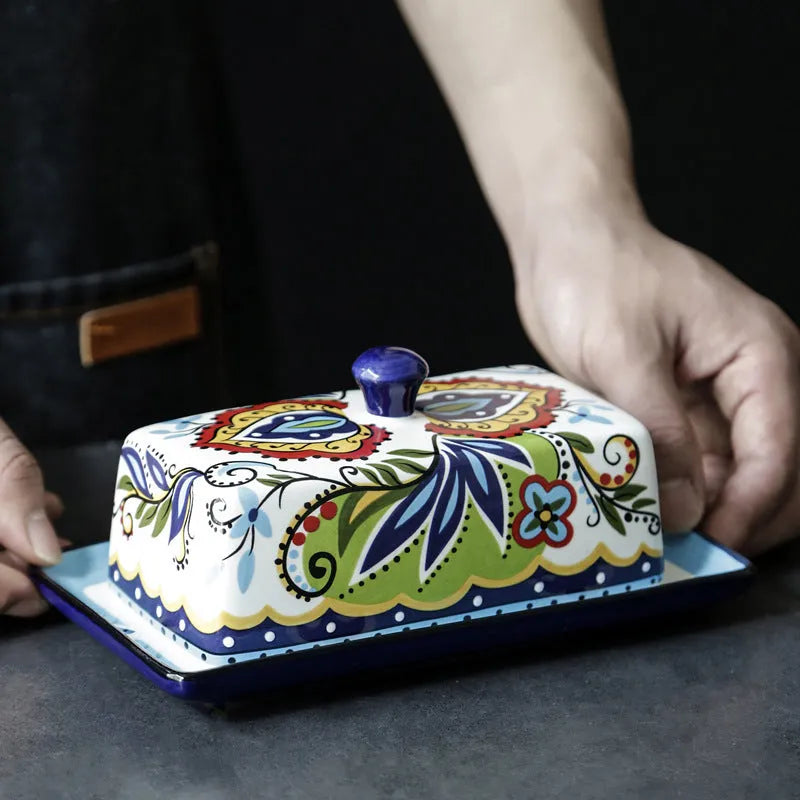 Square ceramic butter box with lid in white, underglaze flower pattern, on kitchen counter