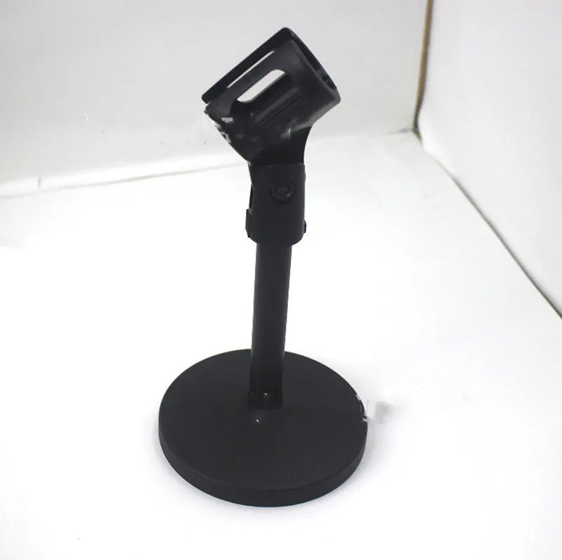Black metal desktop microphone stand with circular base and plastic clip.