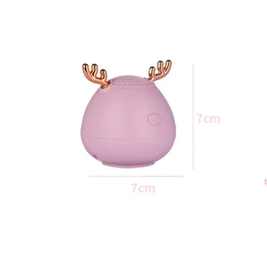 Compact Bluetooth speaker in white, pink, and green, 75x88mm, with USB cable