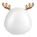 Compact Bluetooth speaker in white, pink, and green, 75x88mm, with USB cable