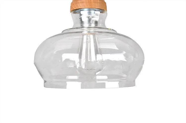 Glass wood grain single head pendant light hanging on an adjustable cord.