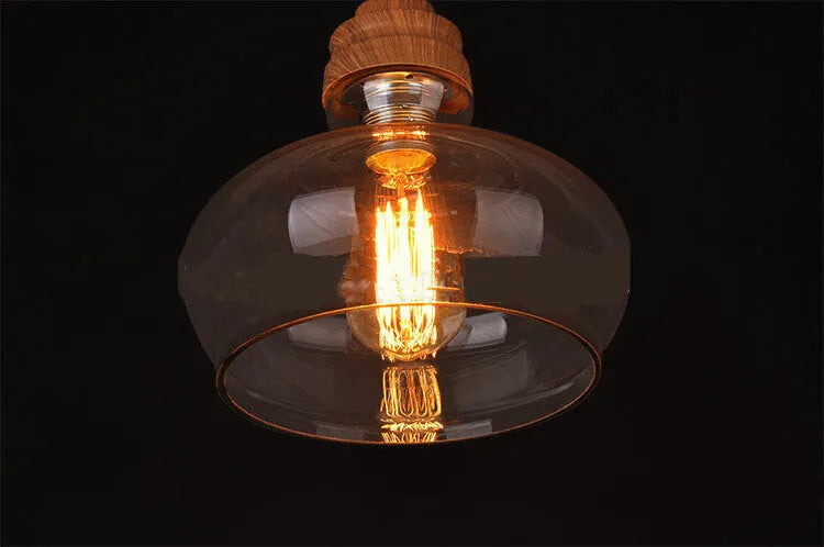 Glass wood grain single head pendant light hanging on an adjustable cord.