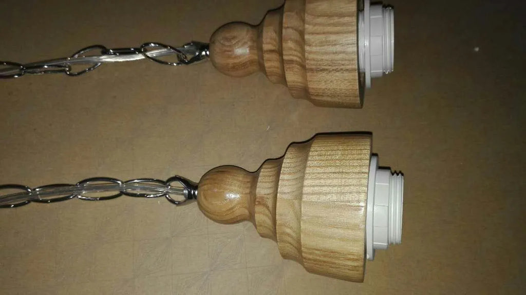 Glass wood grain single head pendant light hanging on an adjustable cord.