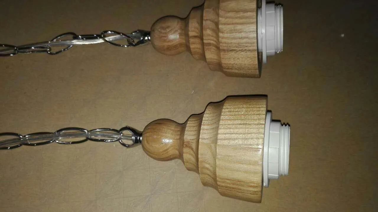 Glass wood grain single head pendant light hanging on an adjustable cord.