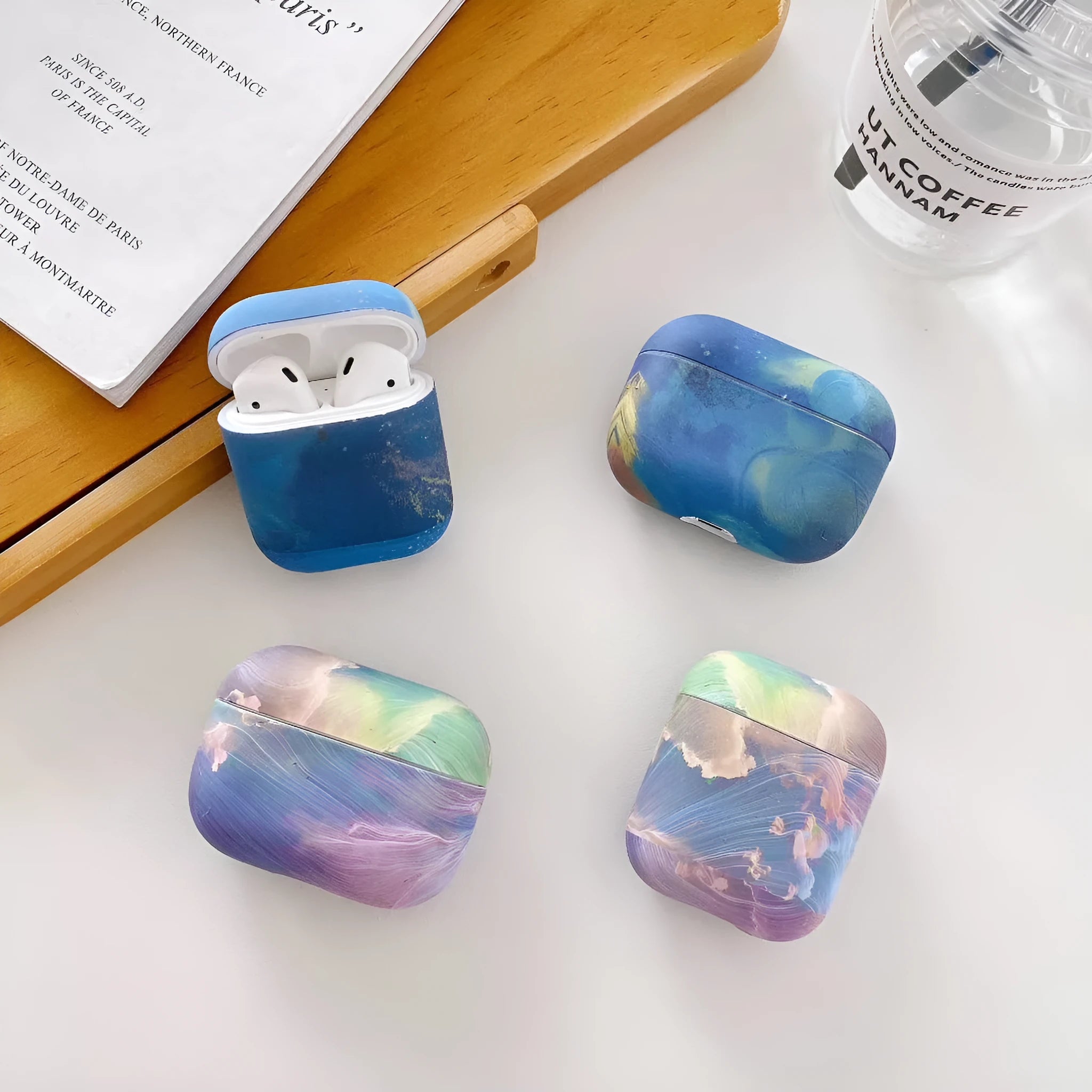 Hard plastic protective case for Apple AirPods with watercolour design in pink or blue options