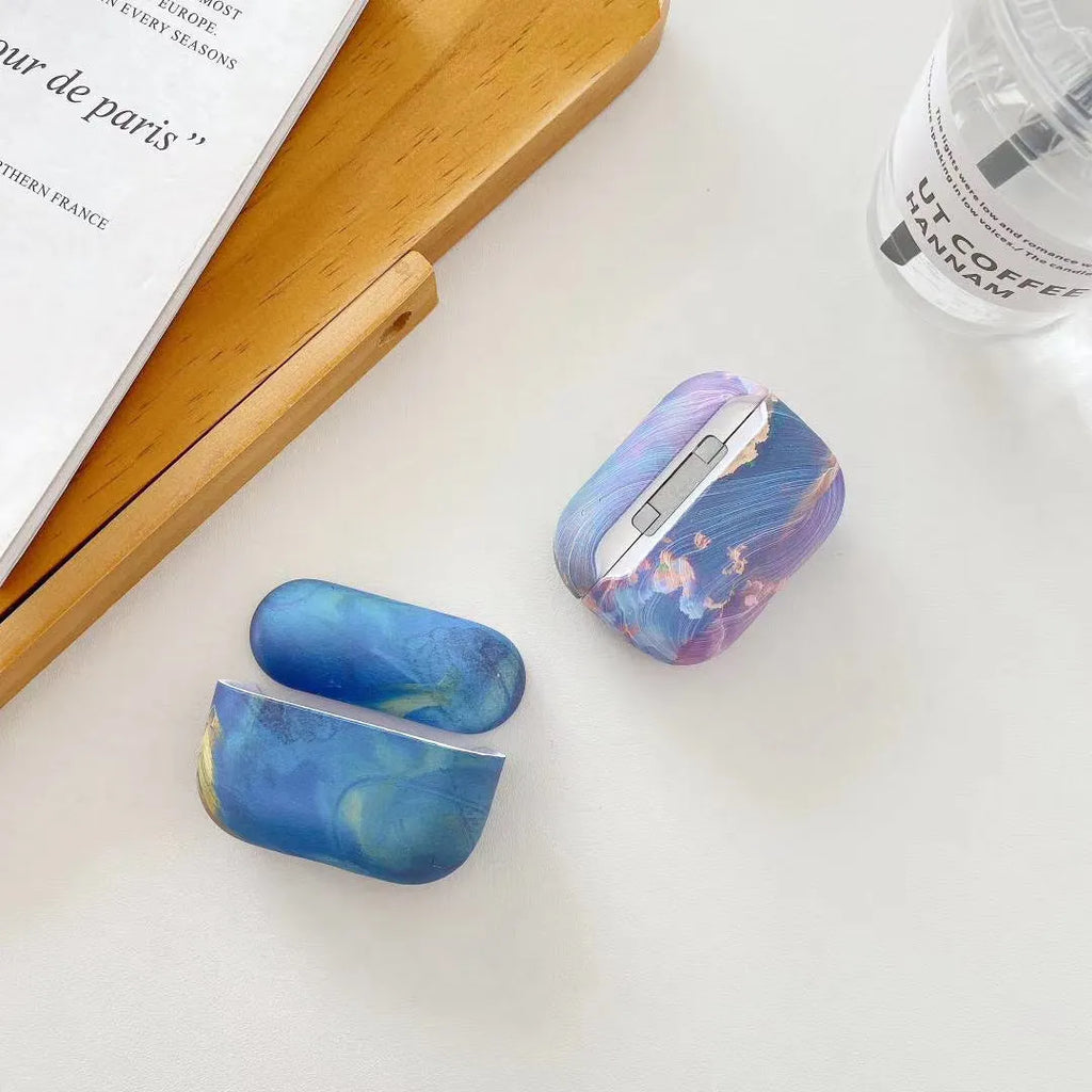 Hard plastic protective case for Apple AirPods with watercolour design in pink or blue options