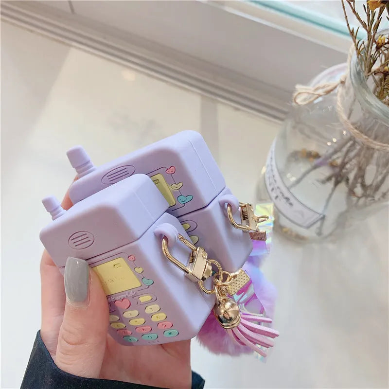 Purple silicone case for Apple wireless headphones with clamshell design and fur ball pendant