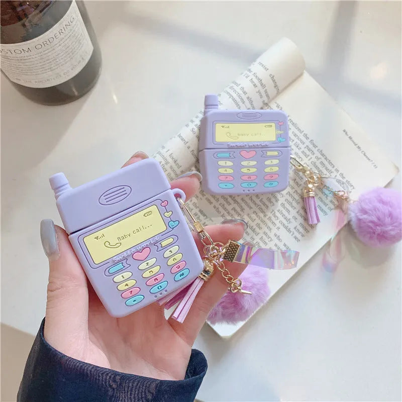Purple silicone case for Apple wireless headphones with clamshell design and fur ball pendant
