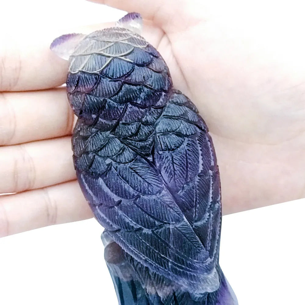Purple fluorite carved owl ornament showing detailed hand-carved features and natural crystal texture