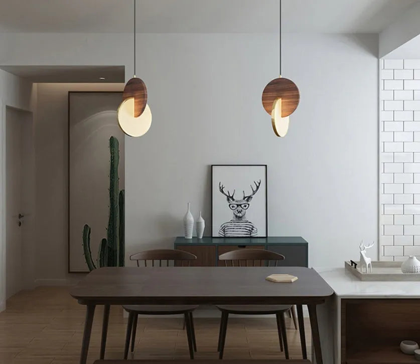 Long-line walnut wood chandelier with carved detailing and warm white lighting