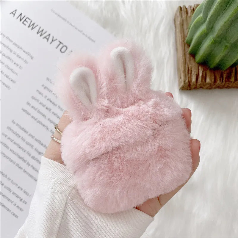 Pink soft silicone Airpod protective cover with grey plush rabbit ears attached to the top.