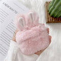Pink soft silicone Airpod protective cover with grey plush rabbit ears attached to the top.