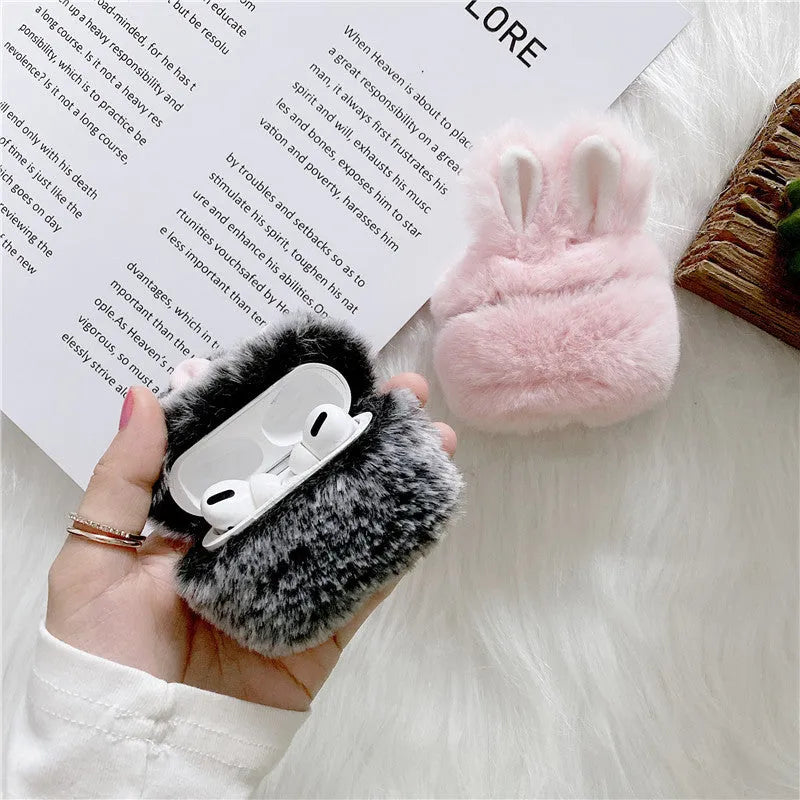 Pink soft silicone Airpod protective cover with grey plush rabbit ears attached to the top.