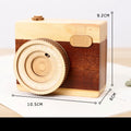Wooden camera design music box with rotating mechanism on a pine wood base.