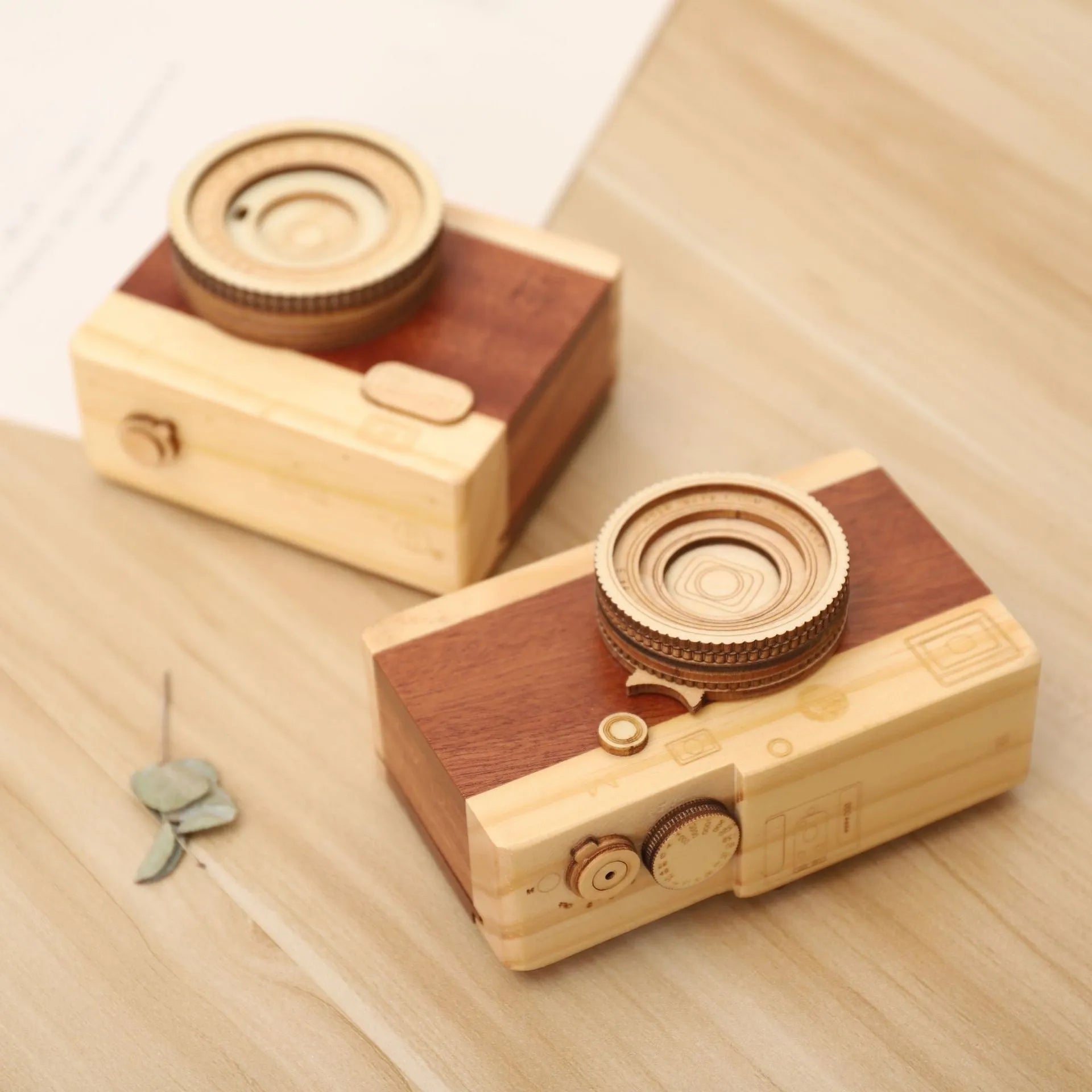 Wooden camera design music box with rotating mechanism on a pine wood base.