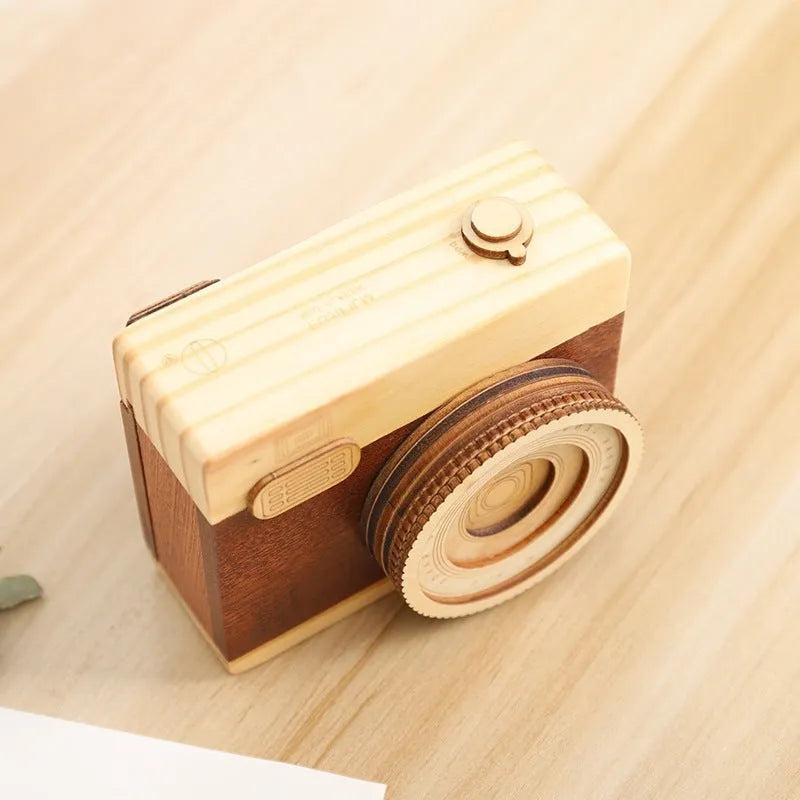 Wooden camera design music box with rotating mechanism on a pine wood base.