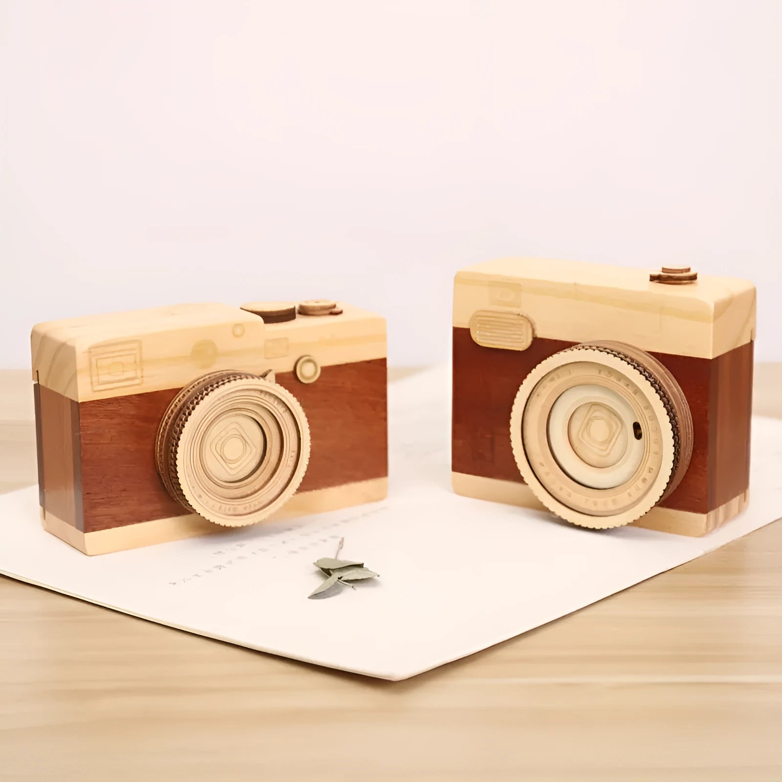 Wooden camera design music box with rotating mechanism on a pine wood base.