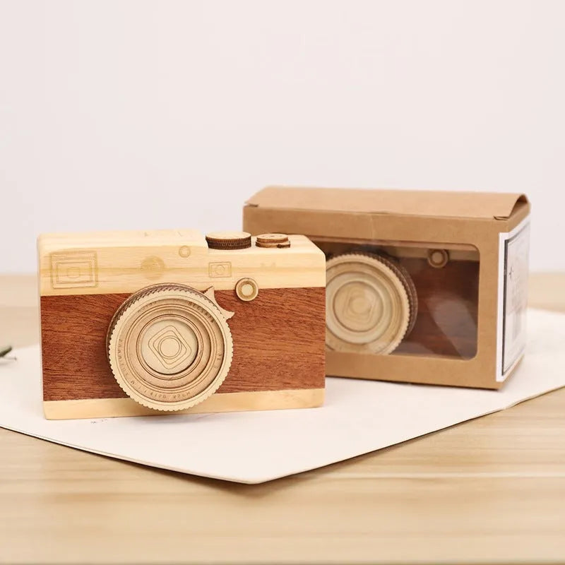 Wooden camera design music box with rotating mechanism on a pine wood base.