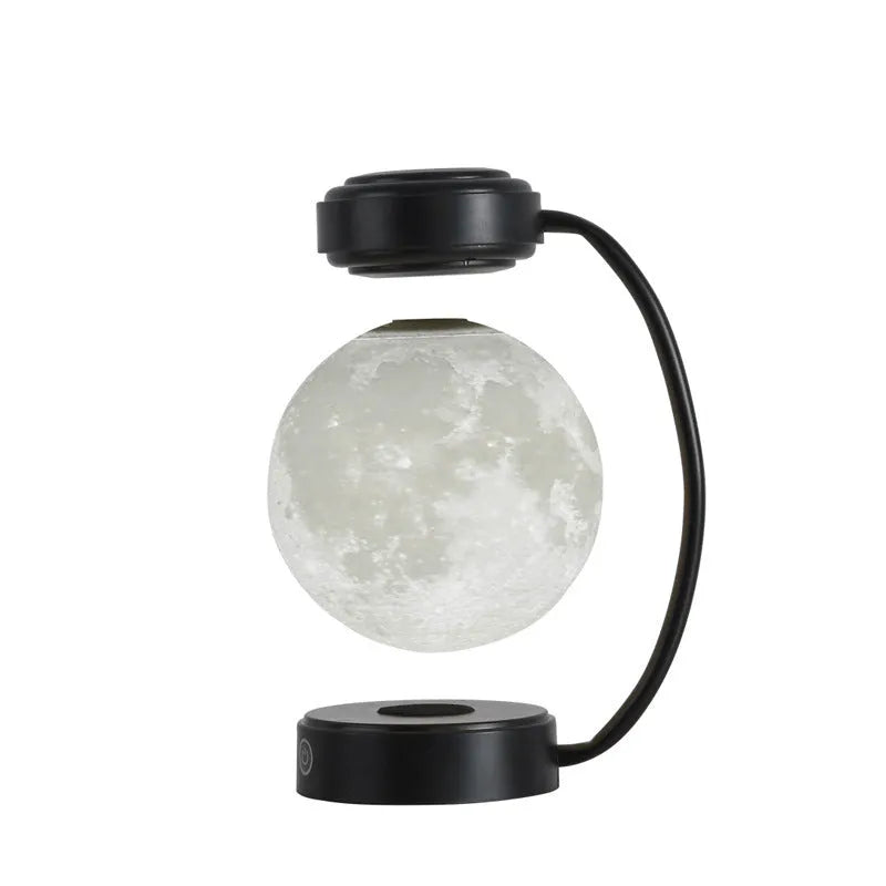 Magnetic levitation moon lamp with 3-colour light changing effect, black elbow base, on a bedside table